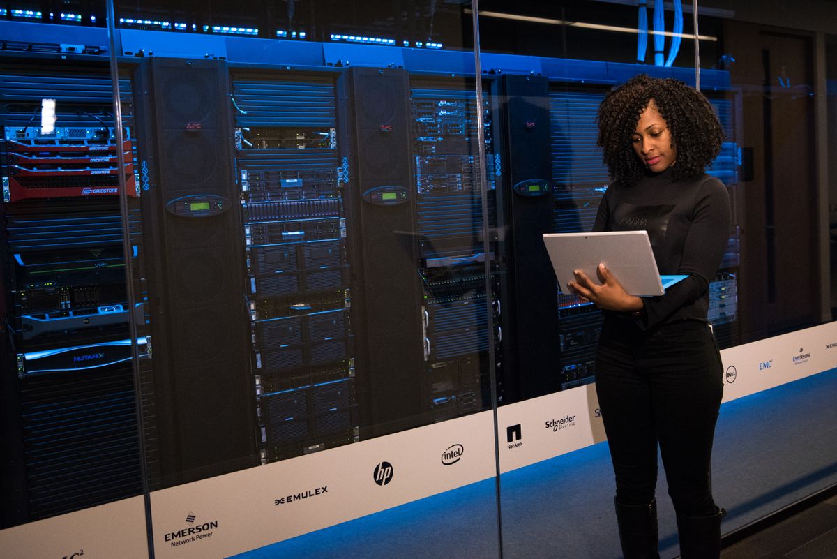 Engineer working on a laptop inside a data center